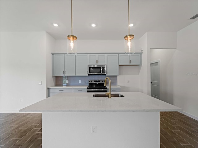 12156 Wellington Ave, Port Charlotte, FL 33981 - kitchen featuring stainless steel appliances, a sink, wood tiled floors, backsplash, and hanging light fixtures