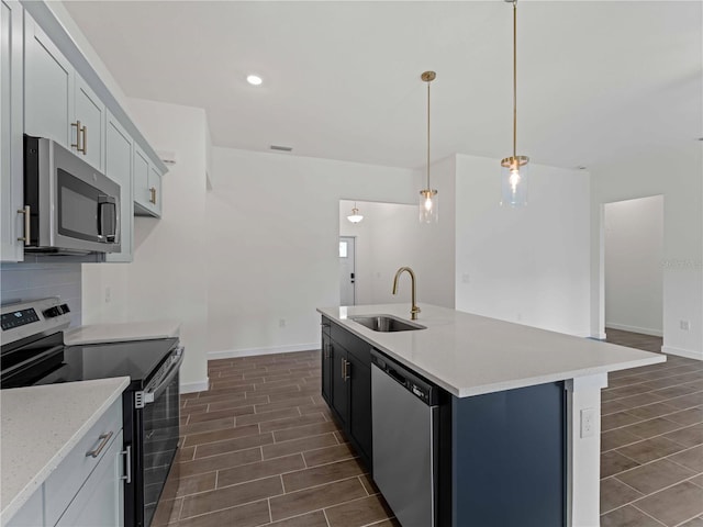 12156 Wellington Ave, Port Charlotte, FL 33981 - kitchen featuring appliances with stainless steel finishes, a sink, wood tiled floors, baseboards, and recessed lighting