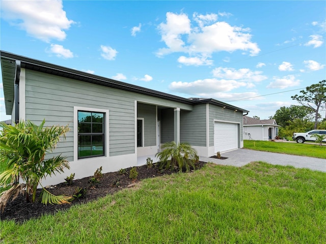 12156 Wellington Ave, Port Charlotte, FL 33981 - view of front of home featuring an attached garage, a front yard, and asphalt driveway