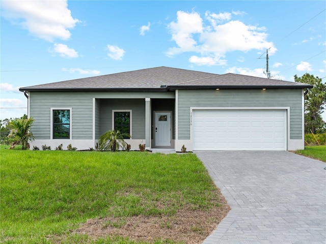 12156 Wellington Ave, Port Charlotte, FL 33981 - view of front of home featuring decorative driveway, an attached garage, and a front lawn