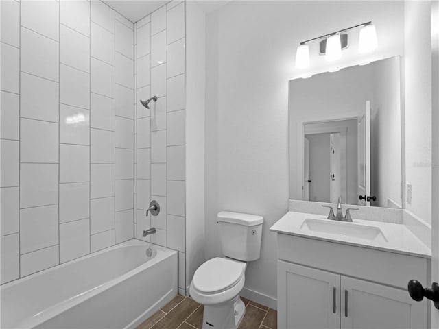 full bath with bathtub / shower combination, toilet, vanity, baseboards, and wood tiled floor