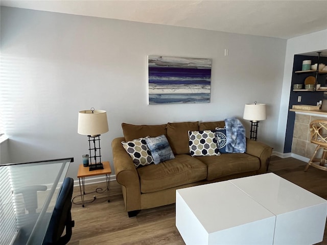 living room with baseboards and wood finished floors