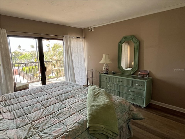 bedroom with access to exterior, baseboards, and wood finished floors