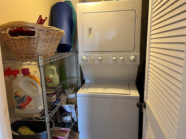 clothes washing area featuring laundry area and stacked washing maching and dryer