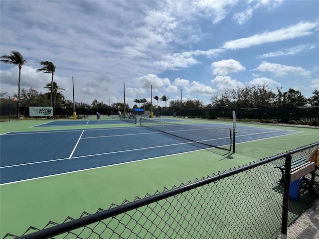 view of sport court featuring fence