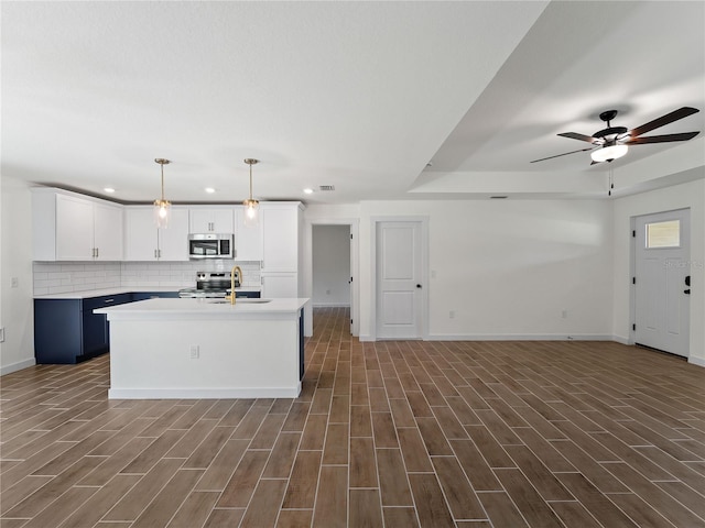17331 Elmwood Ave, Port Charlotte, FL 33948 - kitchen with appliances with stainless steel finishes, light countertops, recessed lighting, open floor plan, and dark wood-style floors