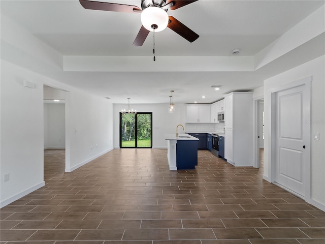 17331 Elmwood Ave, Port Charlotte, FL 33948 - kitchen with stainless steel microwave, open floor plan, dark wood finished floors, blue cabinetry, and recessed lighting