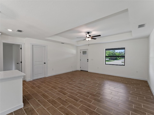 17331 Elmwood Ave, Port Charlotte, FL 33948 - spare room with a tray ceiling, a ceiling fan, dark wood-style flooring, and recessed lighting