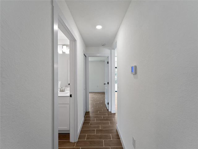 17331 Elmwood Ave, Port Charlotte, FL 33948 - hallway featuring wood finish floors and a textured wall