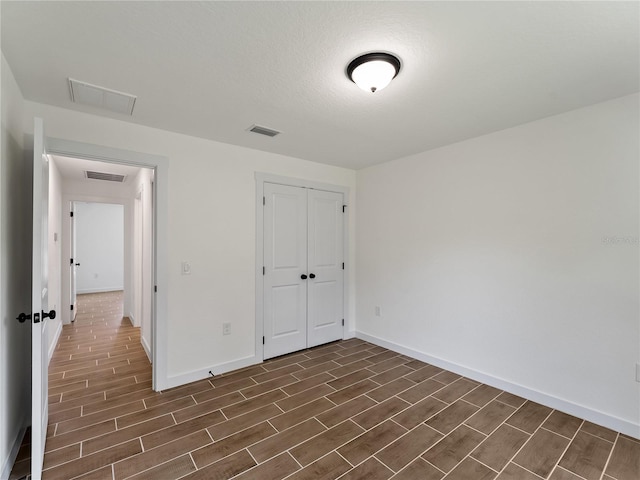 17331 Elmwood Ave, Port Charlotte, FL 33948 - unfurnished bedroom with wood finish floors and a closet