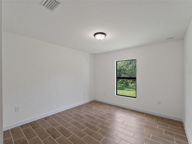 17331 Elmwood Ave, Port Charlotte, FL 33948 - unfurnished room with wood finish floors and a smoke detector
