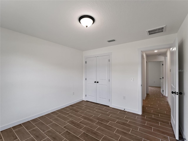 17331 Elmwood Ave, Port Charlotte, FL 33948 - unfurnished bedroom with a closet and dark wood-style flooring