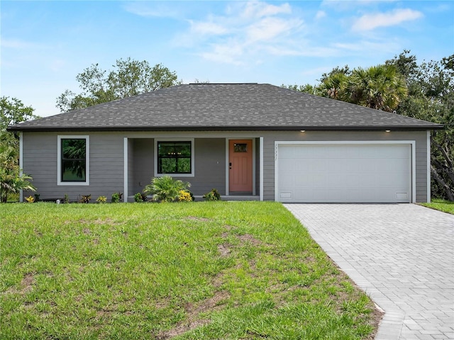 17331 Elmwood Ave, Port Charlotte, FL 33948 - ranch-style home with an attached garage, decorative driveway, a front yard, and a shingled roof