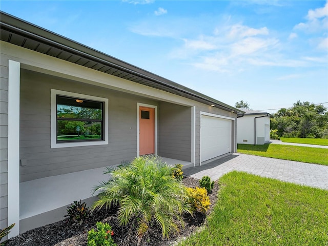 17331 Elmwood Ave, Port Charlotte, FL 33948 - view of front of house with decorative driveway and a front lawn