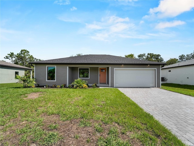 17331 Elmwood Ave, Port Charlotte, FL 33948 - ranch-style home with decorative driveway, an attached garage, and a front yard