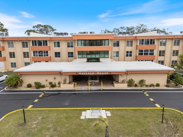 view of property featuring uncovered parking