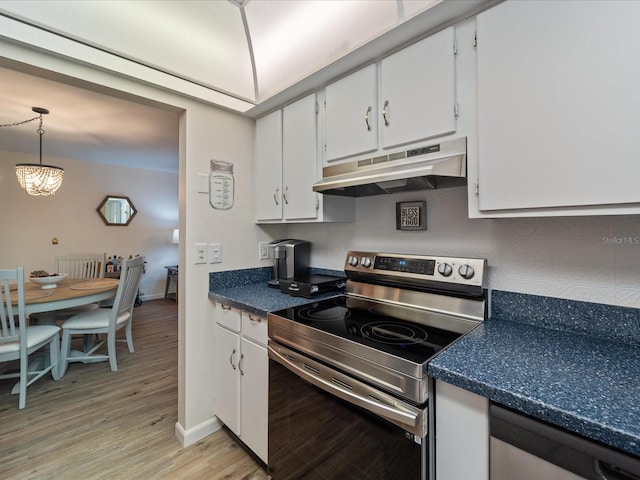 kitchen featuring electric range, white cabinets, light wood-style floors, under cabinet range hood, and dark countertops