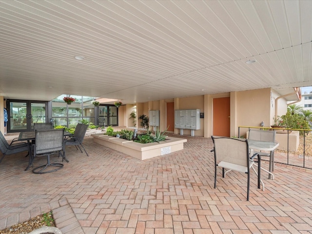 view of patio with outdoor dining area and mail area