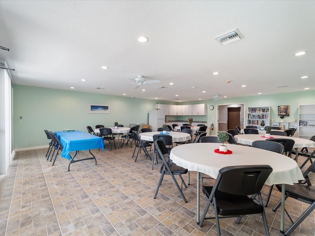 dining area with recessed lighting, visible vents, a ceiling fan, and stone finish flooring