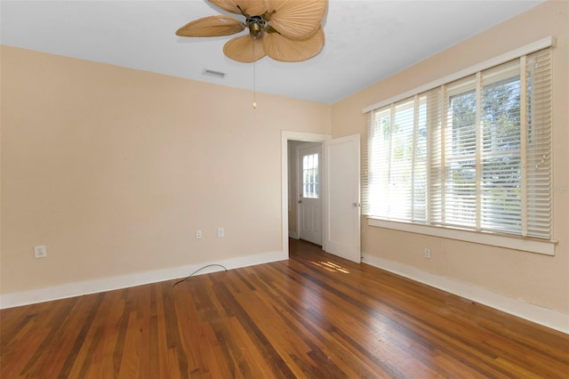 spare room with baseboards, visible vents, ceiling fan, and hardwood / wood-style floors