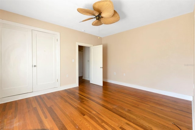 unfurnished bedroom featuring a closet, ceiling fan, baseboards, and wood finished floors