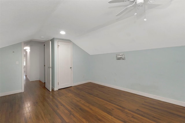 additional living space with hardwood / wood-style flooring, ceiling fan, baseboards, and vaulted ceiling