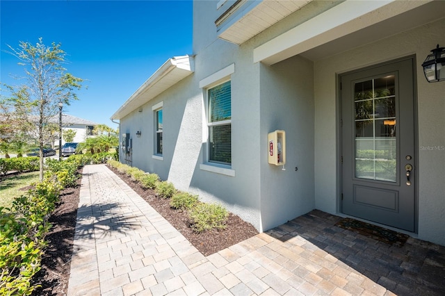 property entrance featuring stucco siding