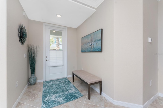 entryway with light tile patterned floors and baseboards