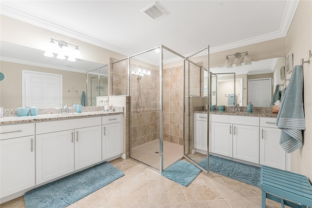 full bath with visible vents, two vanities, a sink, ornamental molding, and a shower stall