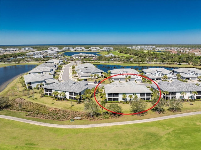 drone / aerial view featuring a water view and a residential view