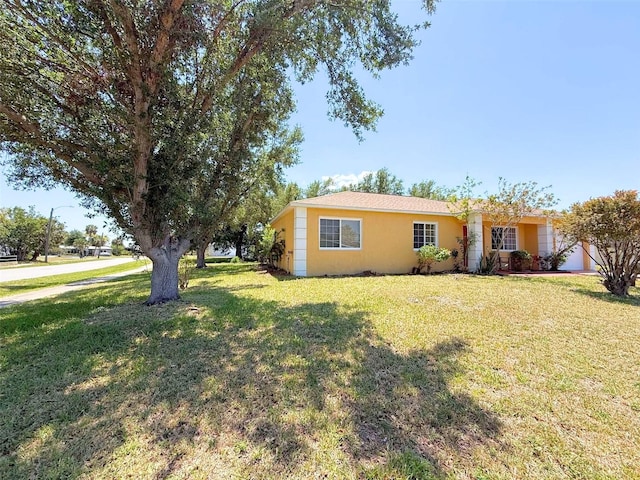 22299 Catherine Ave, Port Charlotte, FL 33952 - view of front facade with a front yard and stucco siding