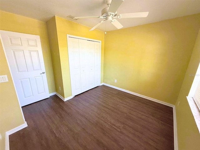 22299 Catherine Ave, Port Charlotte, FL 33952 - unfurnished bedroom with dark wood-style floors, visible vents, a closet, baseboards, and ceiling fan