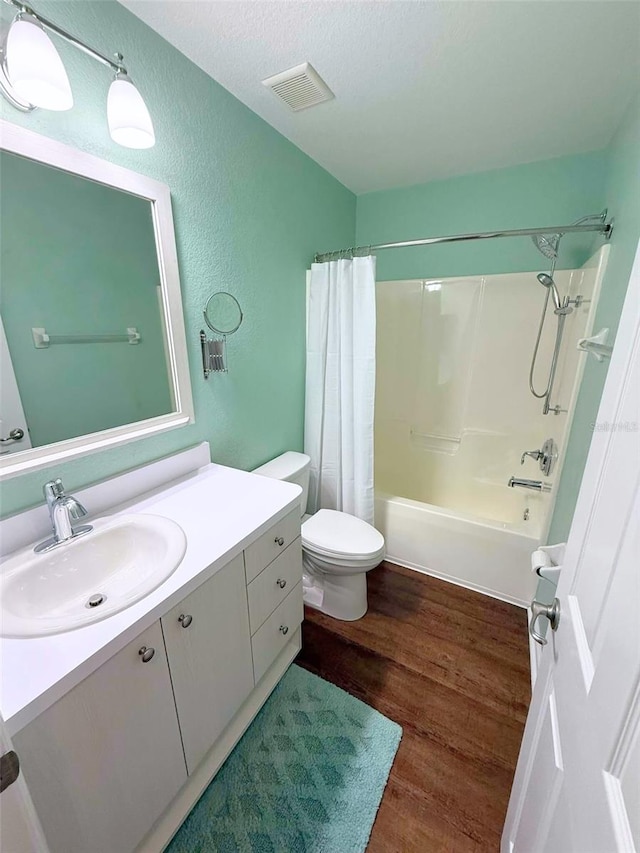 22299 Catherine Ave, Port Charlotte, FL 33952 - full bathroom with wood finished floors, visible vents, toilet, vanity, and a textured wall