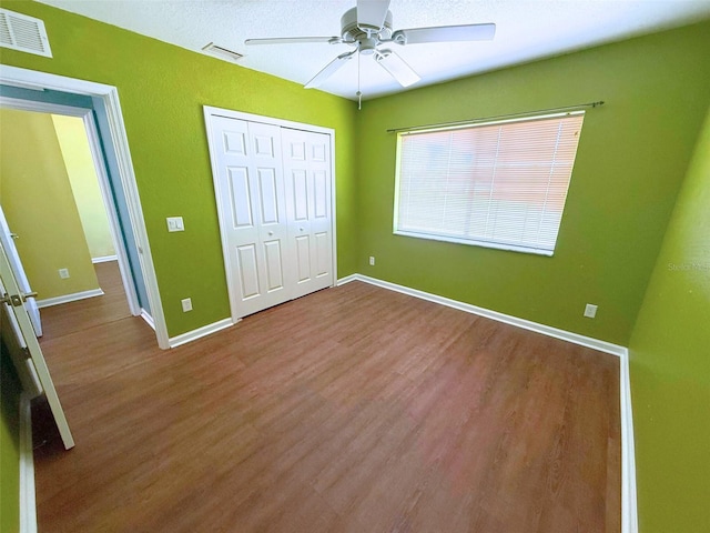 22299 Catherine Ave, Port Charlotte, FL 33952 - unfurnished bedroom with a closet, wood finished floors, visible vents, and baseboards