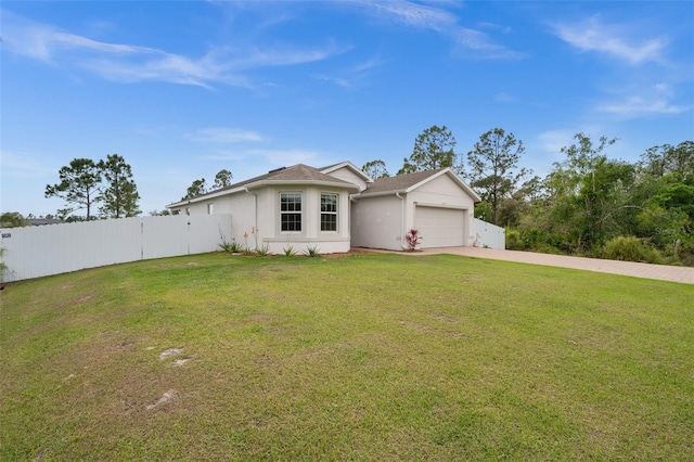 single story home with an attached garage, fence, concrete driveway, stucco siding, and a front yard