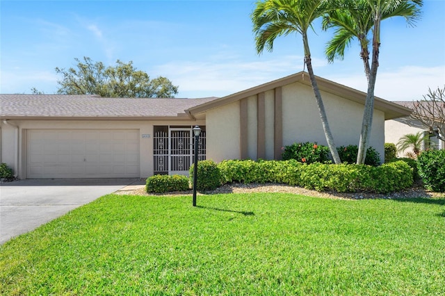 mid-century modern home with a garage, concrete driveway, a front lawn, and stucco siding