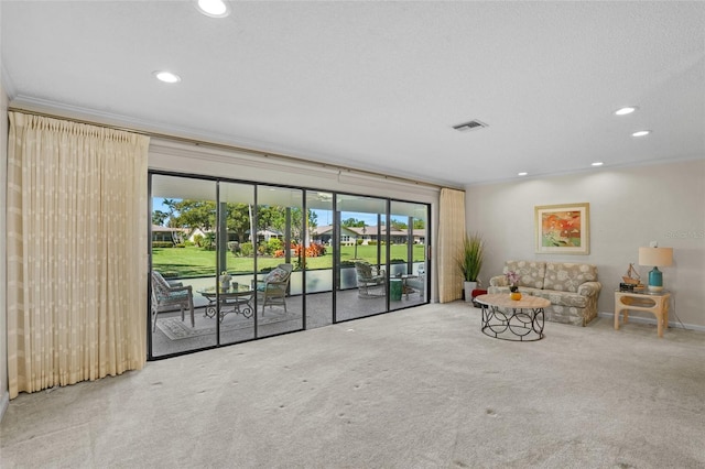 unfurnished living room featuring ornamental molding, carpet, visible vents, and recessed lighting