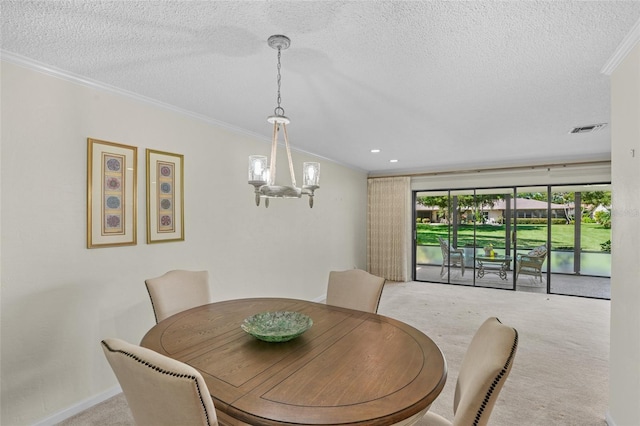 dining room with carpet, crown molding, visible vents, an inviting chandelier, and a textured ceiling