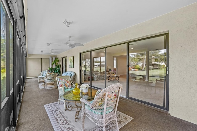 sunroom featuring a ceiling fan