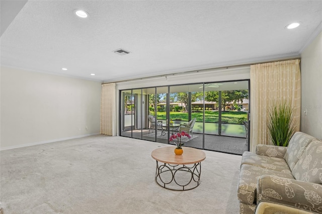 carpeted living room featuring a textured ceiling, recessed lighting, visible vents, baseboards, and ornamental molding