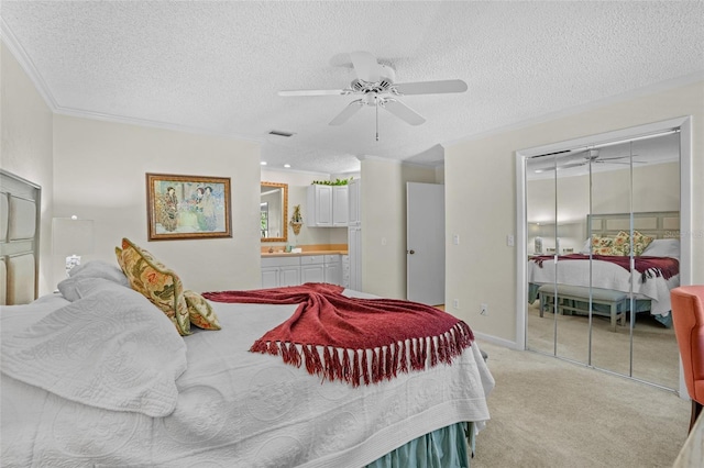 bedroom featuring a textured ceiling, visible vents, crown molding, and light colored carpet