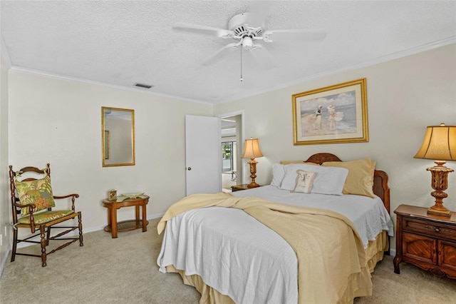 bedroom with visible vents, ornamental molding, light carpet, a textured ceiling, and baseboards