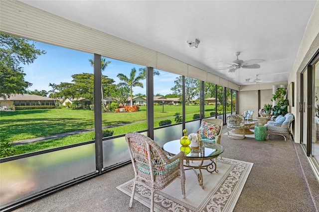 sunroom featuring ceiling fan