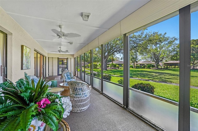 sunroom with a ceiling fan