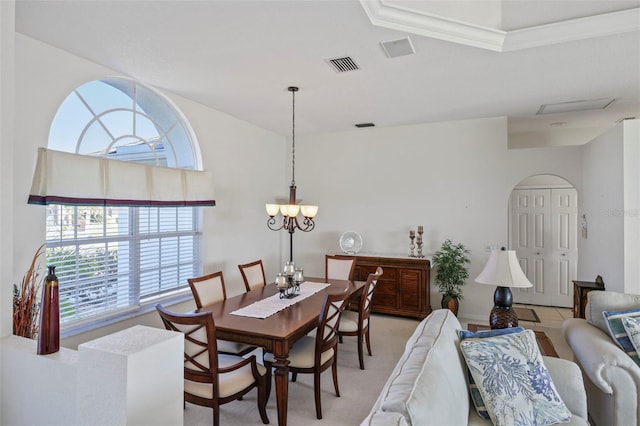 dining space featuring an inviting chandelier, visible vents, and light carpet