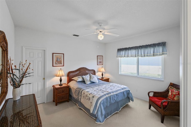 bedroom featuring carpet flooring, ceiling fan, and visible vents