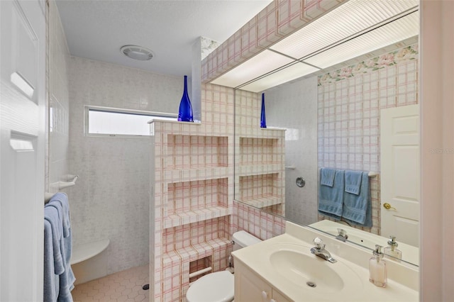 bathroom with vanity, toilet, tile patterned flooring, and walk in shower