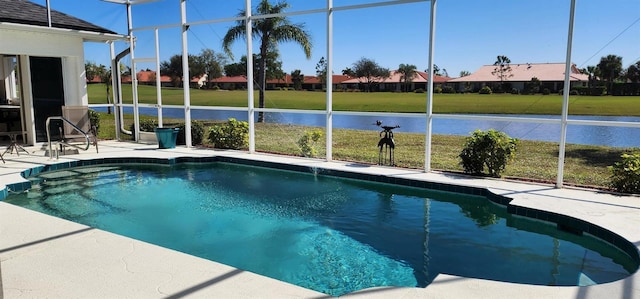 pool with a yard, glass enclosure, and a patio