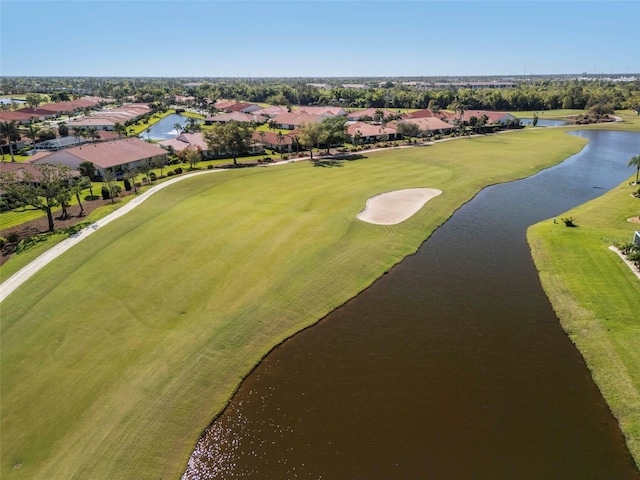 drone / aerial view with a residential view, a water view, and view of golf course