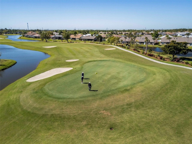 view of home's community featuring a residential view, a water view, and golf course view